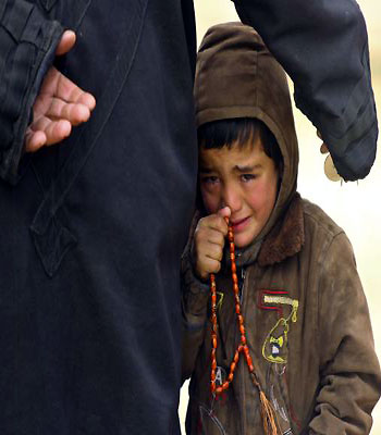 A boy cries while waiting to receive humanitarian aid in the countryside of Idlib. (R)