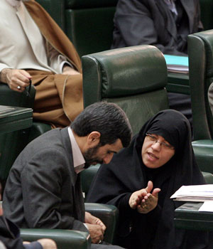 Iranian lawmaker, Fatemeh Ajorlou, talks with President Mahmoud Ahmadinejad, in an open session of parliament to debate on the President's nominee for the post of Oil Minister, in Tehran, Iran, Nov. 23, 2005 (AP)