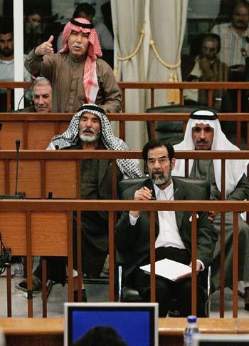 Al-Tikriti addresses the judges at his trial with Saddam in Baghdad's heavily fortified Green Zone (R)