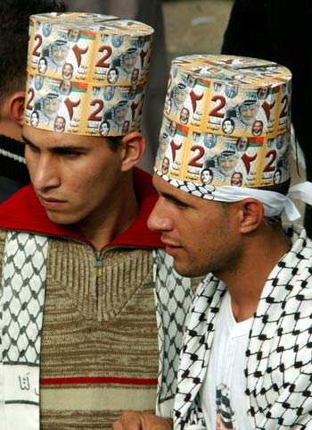 Palestinian students wearing Fatah scarves participate in the elections for the student council at the Al-Najah University (AP)