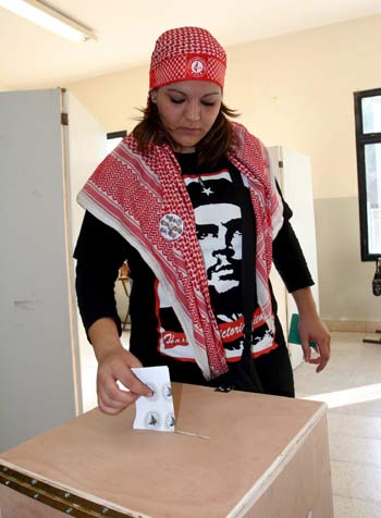 A Palestinian student and PFLP supporter casts her vote for the University council at An-Najah University in Nablus (EPA)