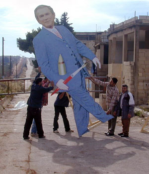 Members of the Lebanese Shiite militia Hezbollah prepare to erect a dummy of US President George Bush, at the Fatima gate on the Lebanese-Israeli border in south Lebanon (AFP)