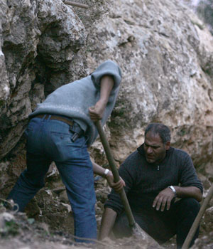 Lebanese inspectors check at a site where bodies were found in a mass grave in the eastern town of Anjar, in the Bekaa Valley, 3 December 2005 (AFP)