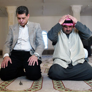 Ehab Lotayef, an envoy of the Canadian Islamic Congress, left, and cleric Ahmed Hassan Taha give weekly Friday Muslim prayers at the al-Imam al-Aadam mosque in Baghdad's predominantly Sunni Arab neighborhood of Azamiyah in north Baghdad, Iraq (AP)