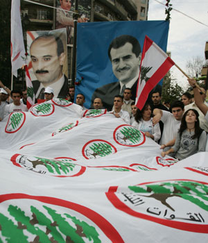 Young supporters of the Christian Lebanese Forces militia mourn the death of Lebanon's prominent anti-Syrian MP and newspaper boss Gebran Tueni (portrait R) in Beirut 12 December 2005 (AFP)