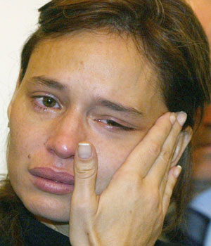 Siham Asseily, wife of slain Lebanese MP Gebran Tueni, cries while accepting condolences at a church in Beirut, December 13, 2005 (REUTERS)