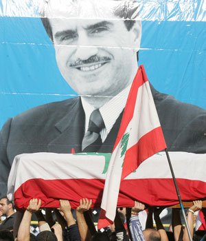 Lebanese mourners carry the coffin of slain anti-Syrian lawmaker and press magnate Gebran Tueni during his funeral in Beirut, 14 December 2005 (AFP)
