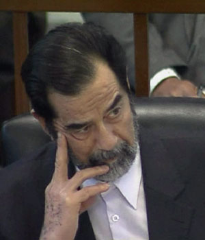 Video grab shows former Iraqi President Saddam Hussein listening to the proceedings of his trial in Baghdad, December 21, 2005 (REUTERS)