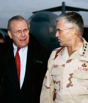 U.S. Secretary of Defense Donald Rumsfeld (L) walks with General George Casey, U.S. Commander in Iraq, after arriving by cargo plane in Baghdad, Iraq December 22, 2005 (REUTERS)