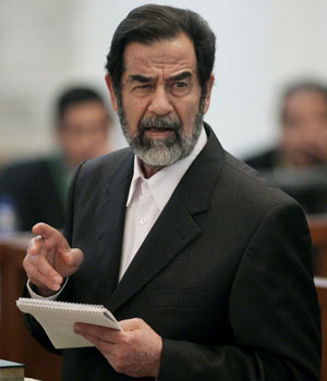 Former Iraqi President Saddam Hussein looks at prosecutors as he speaks at his trial in Baghdad December 22, 2005 (REUTERS)