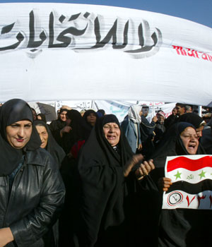 Iraqi women hold up a banner that reads, "No to sectarian elections" as they protest against the results of the recent national elections in western Baghdad, 27 December 2005 (AFP)