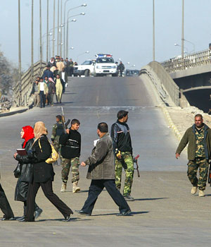 Iraqi soldiers block a main road leading to the scene of a suicide bombing, killing four policemen and wounding five, an interior ministry official said (AFP)