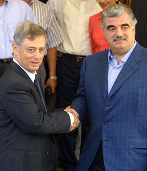 Former late Lebanese Prime Minister Rafik Hariri (R) shakes hands with Syrian Vice President Abdel Halim Khaddam prior to their meeting in Beirut 04 June 2001 (AFP)