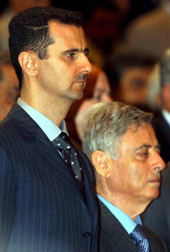 June 2005 picture of Syrian President Bashar Assad (L) and Vice-President Abdul-Halim Khaddam, as they observe a minute of silence for late Syrian President Hafez Assad at the Regional Conference of the Baath party. (EPA)
