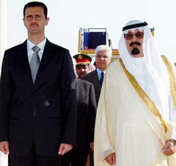 Syria's President al-Assad walks with Saudi Arabia's King Abdullah after arriving in Jeddah (R)