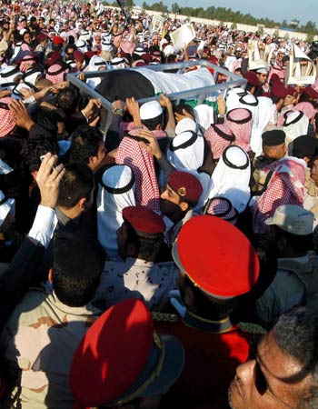 A Kuwaiti mourner brandishes a picture of late Emir Sheikh Jaber al-Ahmad al-Sabah (AFP)