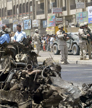 US soldiers and Iraqi police cordon off the area where the bomb exploded in Shula, Northern Iraq (AFP)