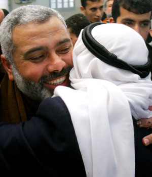 Hamas leader, and top candidate for the Palestinian parliamentary elections, Ismail Haniyeh, left, receives congratulations from supporters inside a mosque after Friday prayers at Shati refugee camp, in Gaza City, Jan. 27, 2006 (AP)