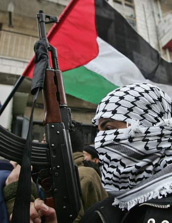 A Fatah militant brandishes his AK-47 during a demonstration in Ramallah (R)