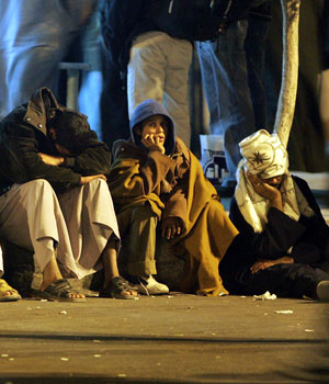 People gather at the entrance to the port in Safaga in Egypt Friday, Feb. 3, 2006 awaiting news of friends and relatives who may have survived the sinking of a ferry in the Red Sea (AP)