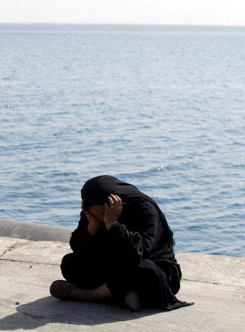 Relatives patiently wait for the arrival of boats bringing survivors, at the dock of Safaga harbour in Egypt (EPA)