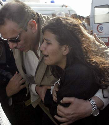 A woman is comforted by a relative after she was rescued from the sea following the sinking of the al-Salam Boccaccio 98 ship (AFP)