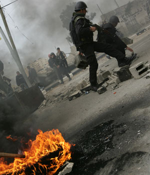 Palestinian riot police secure the area of the Finance Ministry building during a protest by unemployed Palestinian security forces, 09 February 2006 in Gaza City (AFP)