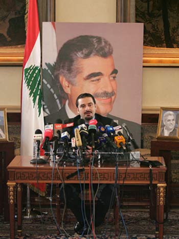 Lebanon's legislator Saad Hariri, son of slain former Prime Minister Rafik Hariri, seen in poster behind him, speaks during a press conference (AP)