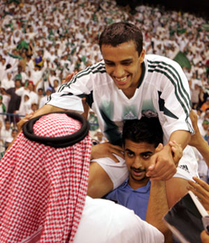 Saudi's Mohamed AlShaboub is carried by supporters after winning their soccer match against Uzbekistan in Riyadh (REUTERS)