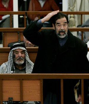 Former Iraqi president Saddam Hussein gestures in court inside the heavily fortified Green Zone in Baghdad, Iraq, Feb. 13, 2006 (AP)