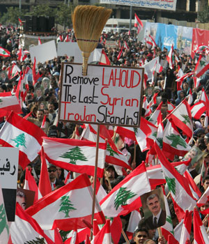 Lebanese demonstrators take part in a mass gathering to mark the first anniversary of premier Rafik Hariri's assassination in central Beirut, 14 February 2006 (AFP)