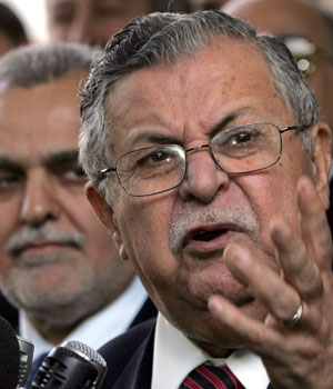 Iraqi President Jalal Talabani (R) gestures as he speaks beside Tareq al-Hashimi, Islamic Party's secretary-general, during a news conference in Baghdad, February 16, 2006 (REUTERS)