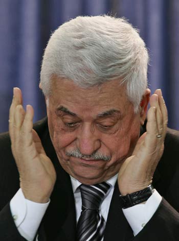 Palestinian President Mahmoud Abbas reacts during the swearing-in of new Palestinian parliament in Ramallah (R)