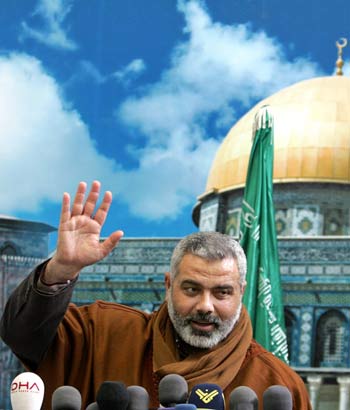 Haniyeh, a senior Hamas leader, gestures during news conference at his house in Shati refugee camp in Gaza (R)