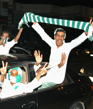 Saudis celebrate on the streets of Jeddah their national soccer teams qualification for next year's World Cup (AP)