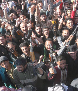 Iraqis chant slogan during a protest against the attack on the holy Shiite shrine of Imam Ali Al-Hadi in Samarra yesterday, in Al-Sadr city, eastern Baghdad, 23 February 2006 (EPA)