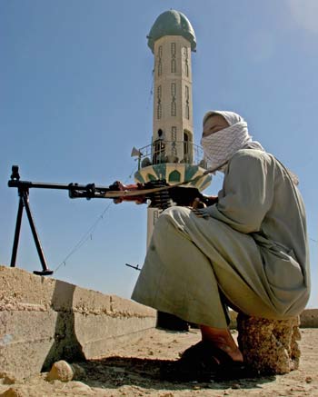 An Iraqi Mehdi Army militant guards a Sunni mosque in the southern city of Basra (AFP)