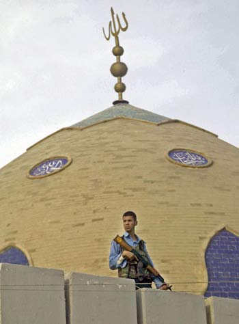 An Iraqi policeman guards Sunni Muslim Scholars Association headquarter in the southern city of Basra (AFP)