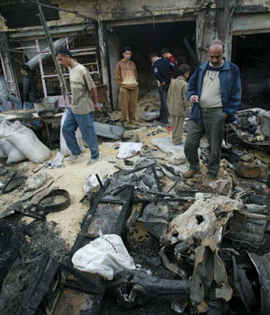 Iraqis gather at the scene of car bomb attack in the Al-Hurya district, north of Baghdad, 01 March 2006 (EPA)
