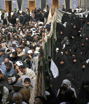 Iraqi Shi'ite men and women sit in separate sections during Friday prayers in the holy city of Kerbala, 100 km (62 miles) south of Baghdad March 3, 2006 (REUTERS)