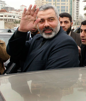 Hamas leader and Palestinian Prime Minister-designate Ismail Haniyeh waves after his meeting with President Mahmoud Abbas in Gaza March 10, 2006 (REUTERS)