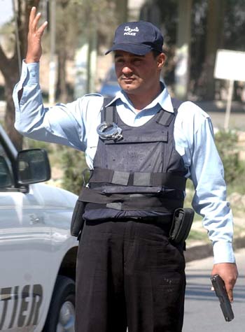 An Iraqi policeman stands at a checkpoint in Baghdad (EPA)