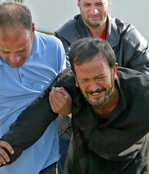An Iraqi mourns the death of his son in Baghdad's poor Sadr City neighborhood, 13 March 2006 (AFP)