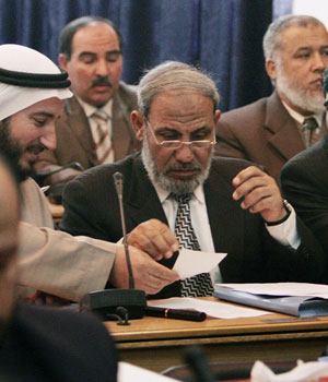 Senior Hamas leader and incoming Minister of Foreign Affairs Mahmoud al-Zahar (C) attends the weekly session of Palestinian parliament in Gaza, March 21, 2006 (REUTERS)