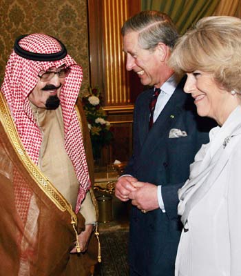 King Abdullah welcomes Britain's Prince Charles and his wife Camilla in Riyadh (R)