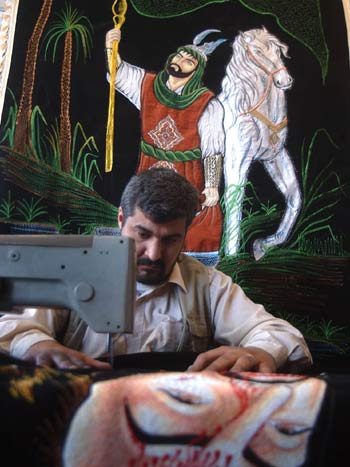 An Iraqi artist sews a cloth wall hanging of Imam Hussein, grand son of prophet Mohammed (AP)