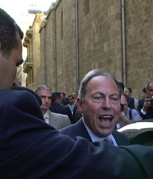 Lebanon's President Emile Lahoud, right, flanked by his bodyguard, reacts after leaving a cabinet session in downtown Beirut, Lebanon, March 30, 2006 (AP)