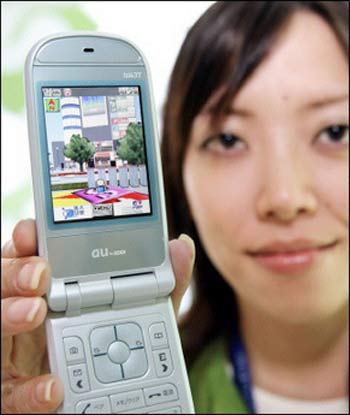 An employee of Japanese mobile communication giant KDDI displays the new mobile phone handset 'W43T' (AFP)
