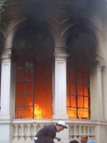 Fire in seen at the headquarters of the Wafd (liberal) party in Cairo (AFP)