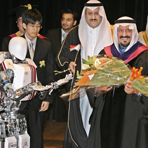 Saudi Arabian Crown Prince Sultan Bin Abdul Aziz (R) receives a bouquet of flowers from humanoid robot "Wabian II" buit by the Waseda University during his honorary doctorate conferral ceremony in Tokyo, 07 April 2006 (AFP)